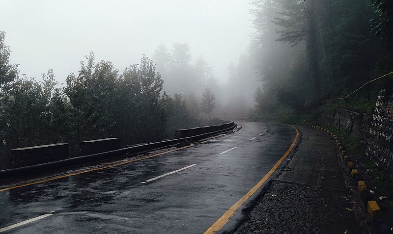 A photograph of a foggy road.